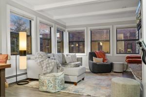 a living room with a couch and chairs and windows at Chic 2BDR Downtown Condo Walk Everywhere in Breckenridge