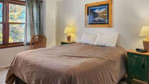 a bedroom with a bed and a chair and a window at Manorhouse Hideaway in Dillon +22 photos