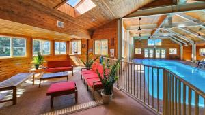 a room with a swimming pool and red chairs at 1BR Rustic Retreat Near Trails and Slopes in Dillon