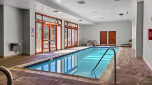 a swimming pool in a hotel room with a large window at Cozy 2BD Near Free Shuttle and Ski Lifts in Dillon