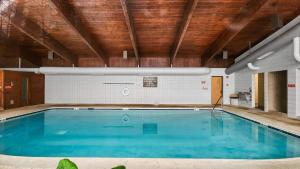 a swimming pool in a building with a wooden ceiling at 1BDR by Free Shuttle & Ski Lifts in Dillon