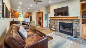 a living room with a couch and a fireplace at Bright Baldy 2BD Near Trailheads in Breckenridge