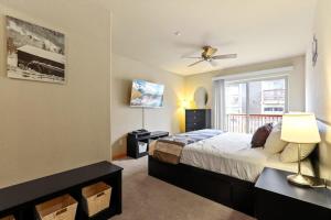 a bedroom with a bed with a ceiling fan and a window at 2BR Condo - Ideal Hub for Year-Round Fun in Silverthorne +22 photos