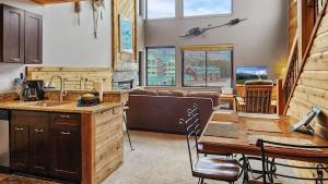 a kitchen and living room with a table and a couch at Chic Lakeside 1BR 4-Min to Keystone Resort in Keystone