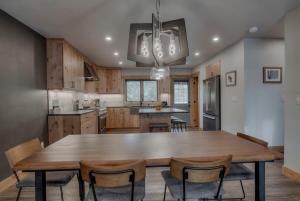 a kitchen with a large wooden table and chairs at Ski In Out Townhome with Hot Tub and Lovely Mtn Views in Breckenridge