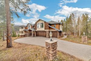 a large house with a driveway and a garage at Highlands Ridge Retreat Massive 9 BDR Estate in Breckenridge