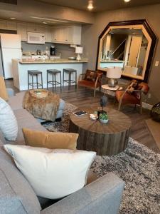 a living room with a couch and a table at Breathtaking Mountain Views Ski In Out 2BR Condo in Park City