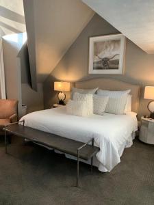 a bedroom with a large white bed with two lamps at Breathtaking Mountain Views Ski In Out 2BR Condo in Park City