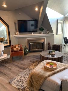 a living room with a couch and a fireplace at Breathtaking Mountain Views Ski In Out 2BR Condo in Park City