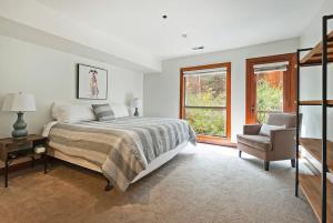 a bedroom with a bed and a chair and a window at Stunning Location 2BDR Condo Retreat in Park City