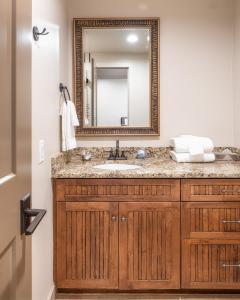 a bathroom with a sink and a mirror at Ski In Out 3 BDR Condo with Stunning Mountain Views in Park City +30 photos