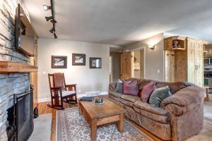 a living room with a couch and a fireplace at Quaint 2BR Retreat Heart of Town Steps from Lift in Park City