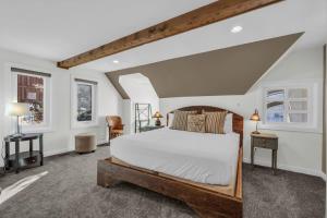 a bedroom with a large bed and two windows at Roomy 4BR Townhome Near Main St with Private Hot Tub in Park City