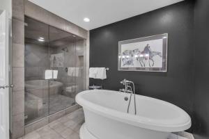 a bathroom with a white tub and a shower at Roomy 4BR Townhome Near Main St with Private Hot Tub in Park City +21 photos