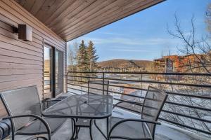 a balcony with a table and chairs and a view at Steps From Ski Lift Garage Parking Included in Park City