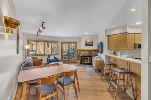 a kitchen and living room with a table and chairs at Steps From Ski Lift Garage Parking Included in Park City
