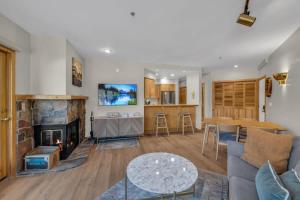 a living room with a couch and a fireplace at Steps From Ski Lift Garage Parking Included in Park City