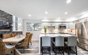a kitchen with a table and chairs and a kitchen with white cabinets at Remodeled 4BR Close to Canyons Village and Skiing in Park City
