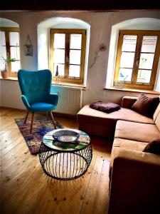 a living room with a couch and a chair and a table at Ferienwohnung für 3 Personen ca 55 qm in Görlitz, Lausitz Lausitzer Seenland - b55639 in Görlitz