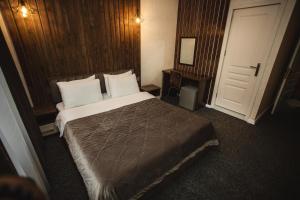 a hotel room with a bed and a door at Moss Art Boutique Hotel in Baku