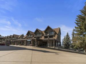 a large house on a street with trees at Cozy 1BR Resort Living with Ski Lift Seconds Away in Park City
