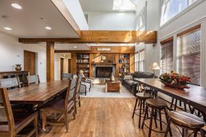 a living room with a large wooden table and chairs at Intimate 2BDR in Heart of Town Walk to Ski Lift in Park City
