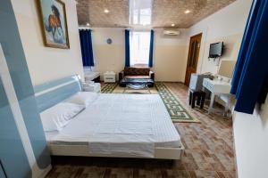 a hotel room with a bed and a desk at YAN HOTEL in Yerevan