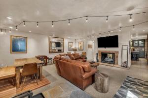 a living room with a couch and a fireplace at Rustic 2BR Steps from Main St in Park City