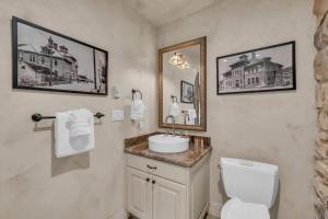 a bathroom with a white toilet and a sink at Rustic 2BR Steps from Main St in Park City +18 photos
