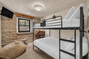 a bedroom with two bunk beds and a desk at Rustic 2BR Steps from Main St in Park City
