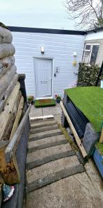 a set of stairs leading to a garage with a door at Four Winds Holiday Let in Nairn