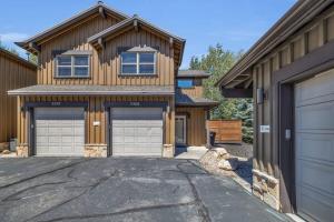 a house with two garage doors in a driveway at 2BD with Hot Tub Near Ski Resorts and Trails in Park City