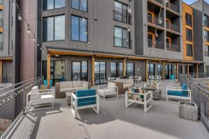 a patio with chairs and tables in front of a building at 1BR in the Heart of Canyons Village in Park City