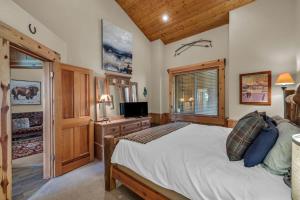 a bedroom with a bed and a television in a room at Luxurious 2BDR in Deer Valley with Hot Tub in Park City