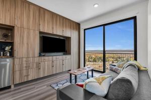 a living room with a couch and a large window at Chic Ski-in Ski-out Studio at Canyons Village in Park City