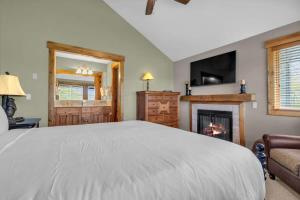 a bedroom with a large bed and a fireplace at Ski In Ski Out 3BR Steps from Ski Resort in Park City