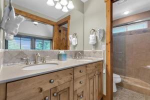 a bathroom with two sinks and a shower at Ski In Ski Out 3BR Steps from Ski Resort in Park City
