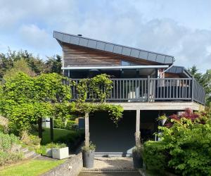 a house with a balcony on top of a yard at Luxurious villa south Dublin in Dublin