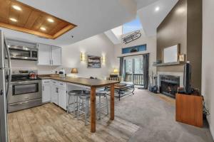a kitchen with a table and chairs and a fireplace at 2BD Condo with Ski Run Views and Hot Tub Access in Park City +18 photos