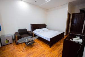 a small bedroom with a bed and a chair at YAN HOTEL in Yerevan