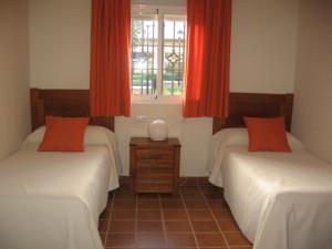 Postel nebo postele na pokoji v ubytování Hotel Sierra Luz