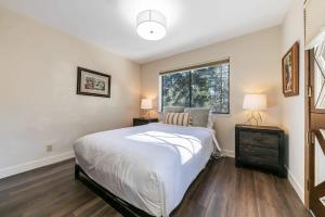 a bedroom with a large bed and a window at Tahoe Vista Retreat with Lake View Walk to beach in Tahoe Vista