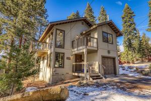 a house in the woods with a balcony at Tahoe Vista Retreat with Lake View Walk to beach in Tahoe Vista