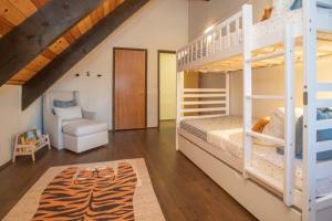 a bedroom with two bunk beds and a chair at Chalet Blue Modern 4BD Tahoe Home in Tahoe City