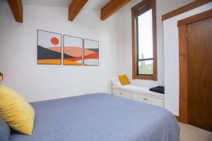 a bedroom with a blue bed and a window at One BDR at Northstar Walk to Village in Truckee +18 photos