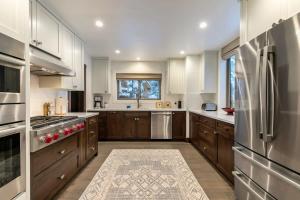 a kitchen with wooden cabinets and a stainless steel refrigerator at North Lake Tahoe Cabin and Hot Tub in Tahoe City
