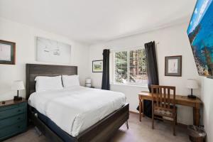 a bedroom with a bed and a desk and a window at Bright 3BDR Near Beach and Slopes in Kings Beach