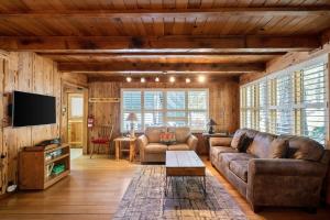 a living room with a couch and a tv at 3BR Mountain Cabin-Near Beach & Slopes in Homewood