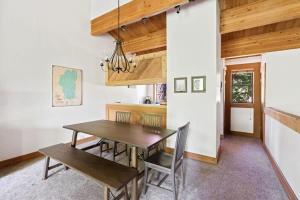 a dining room with a wooden table and chairs at Bright 2BDR Next to NorthStar - 5min Walk! in Truckee