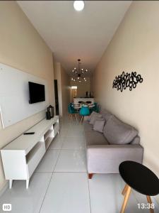 a living room with a couch and a table at DUNAS RESIDENCE CASA 14 in Santo Amaro